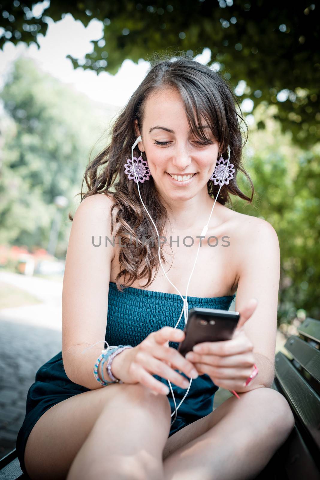 beautiful woman listening to music by peus