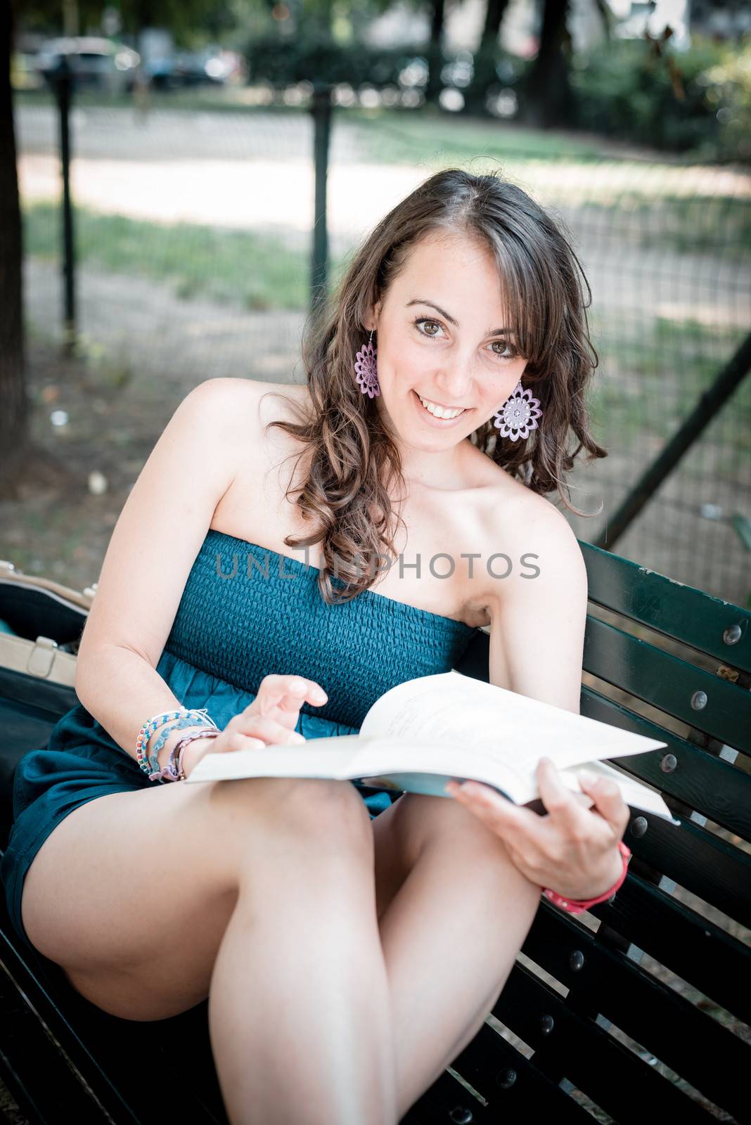 beautiful woman reading book in the city
