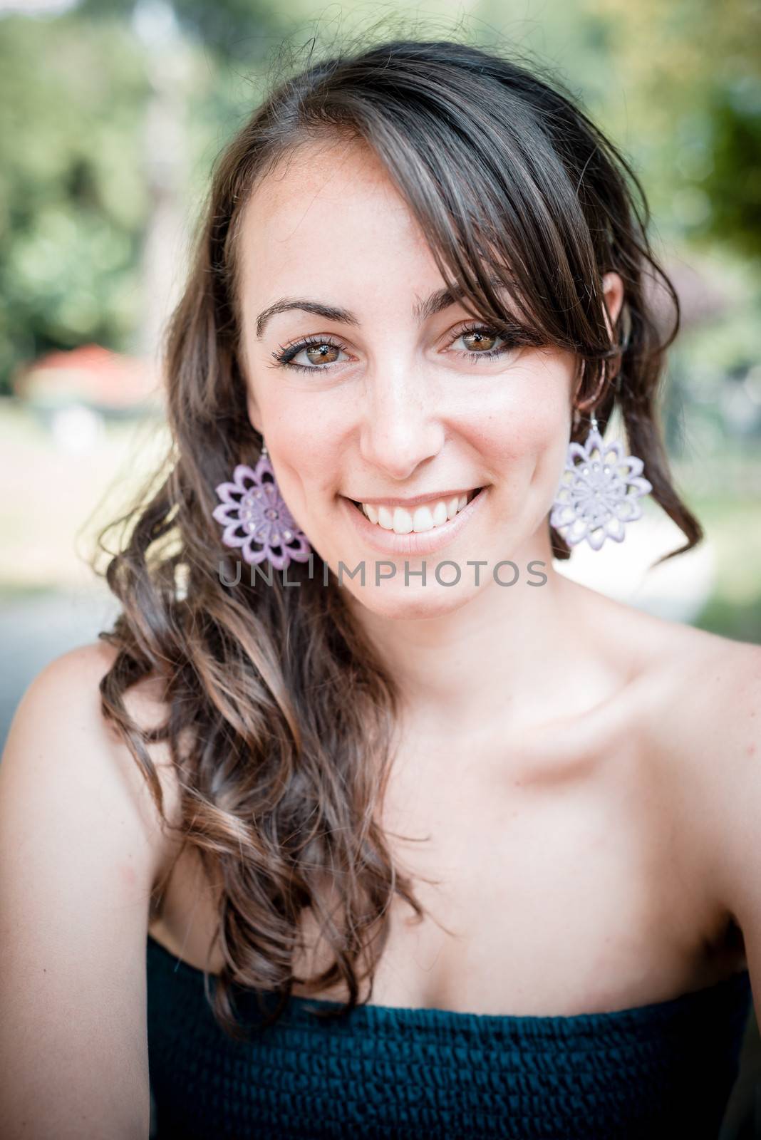 closeup portrait of smiling beautiful woman in the city