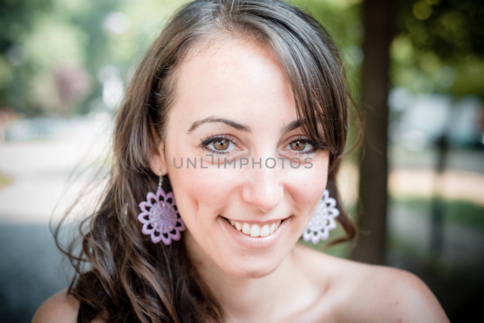 closeup portrait of smiling beautiful woman in the city