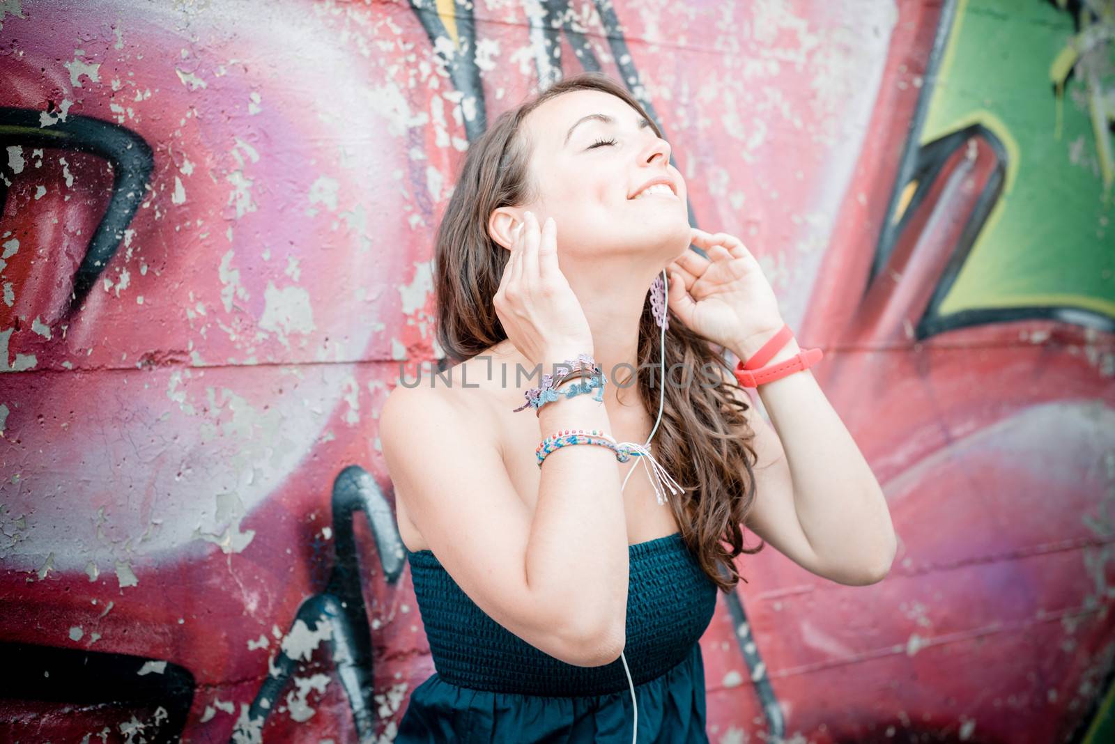 beautiful woman listening to music by peus