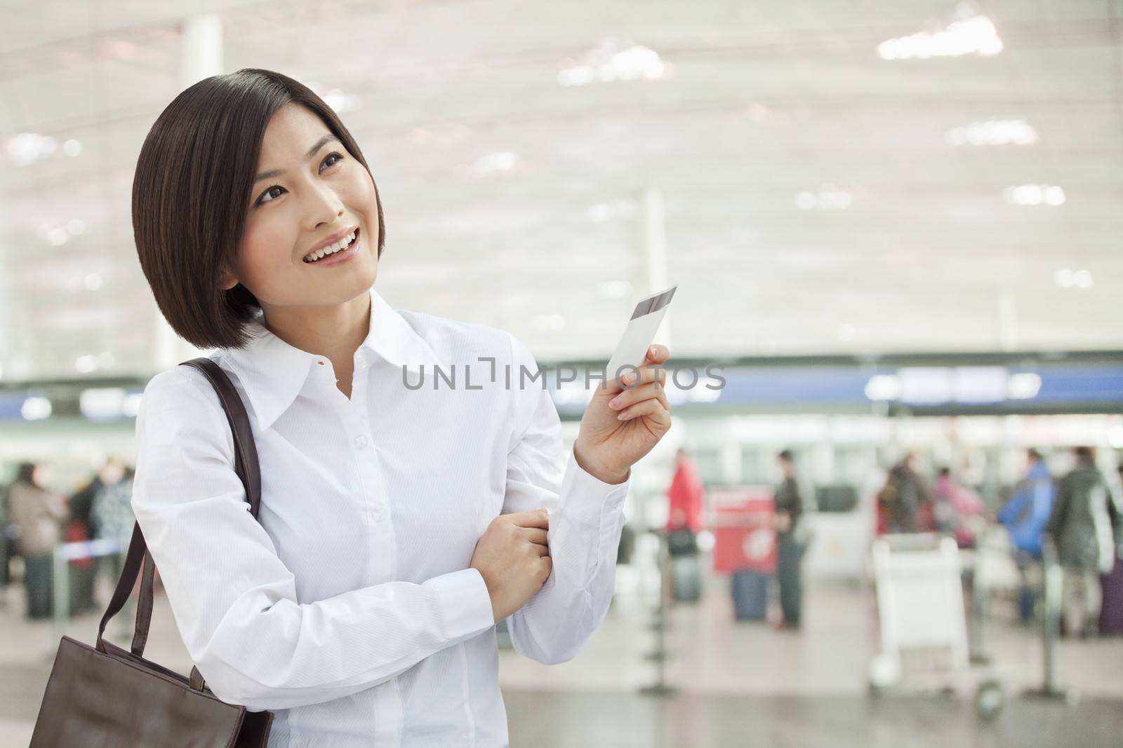 Young Woman Holding an Airplane Ticket