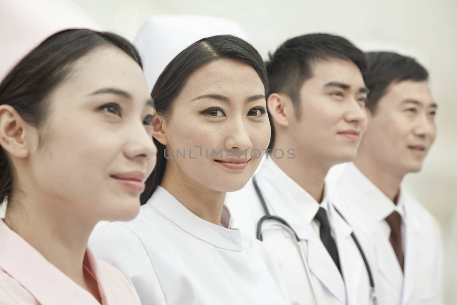 Healthcare workers standing in a row, China by XiXinXing
