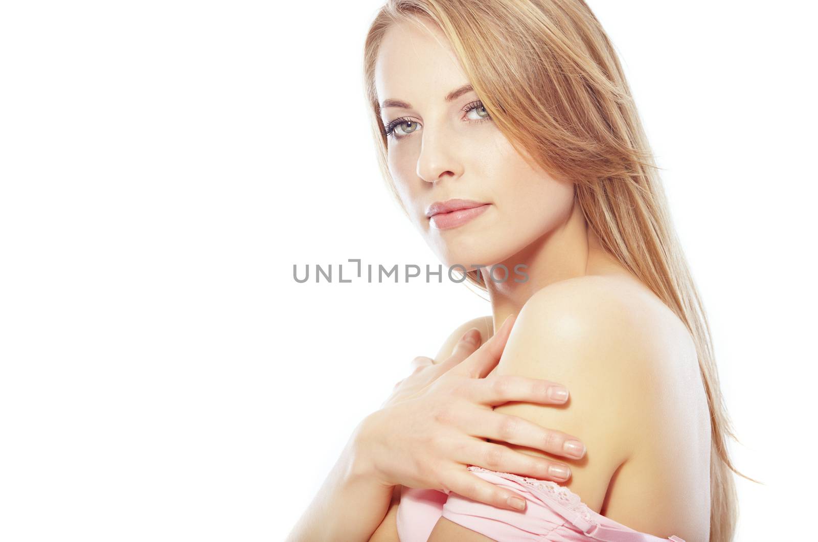 Sexy lady in pink dress with revealed shoulder on a white background