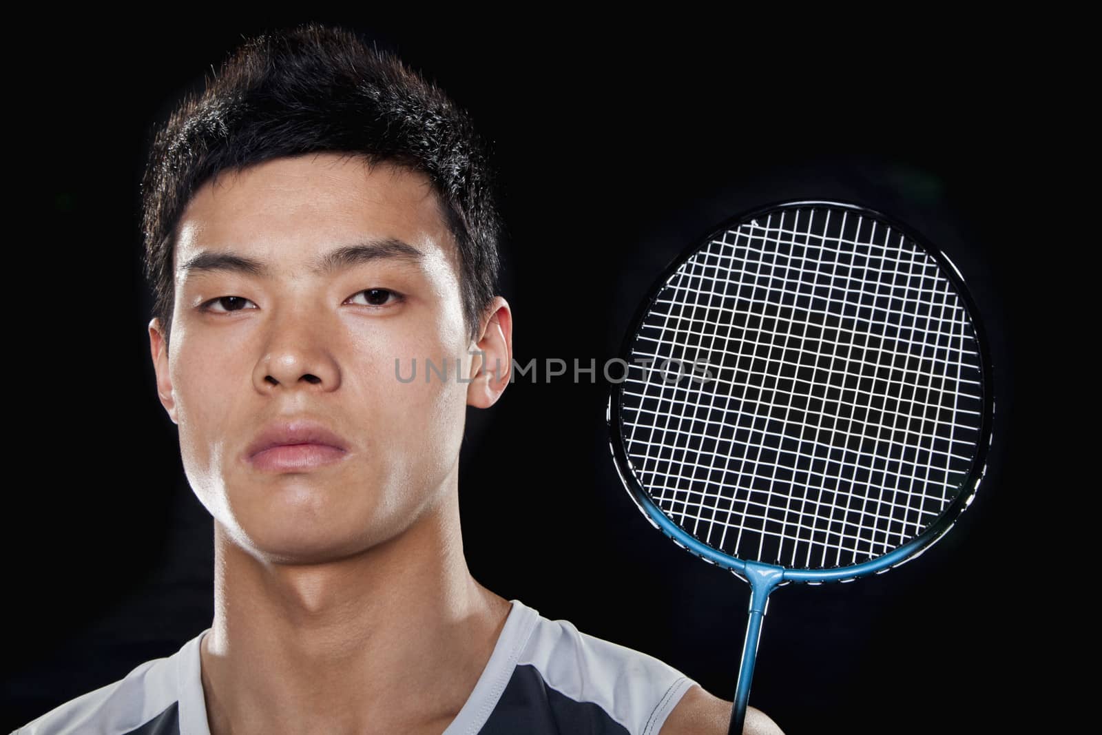 Man with badminton racket, portrait