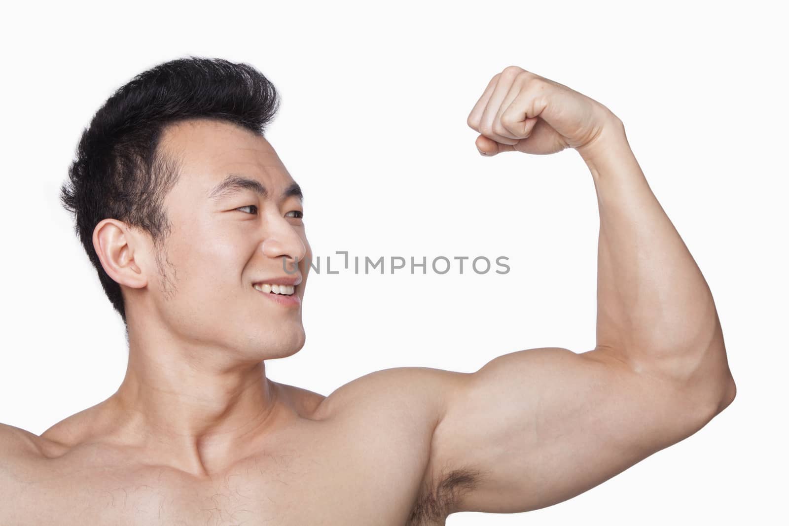 Young man showing off bicep