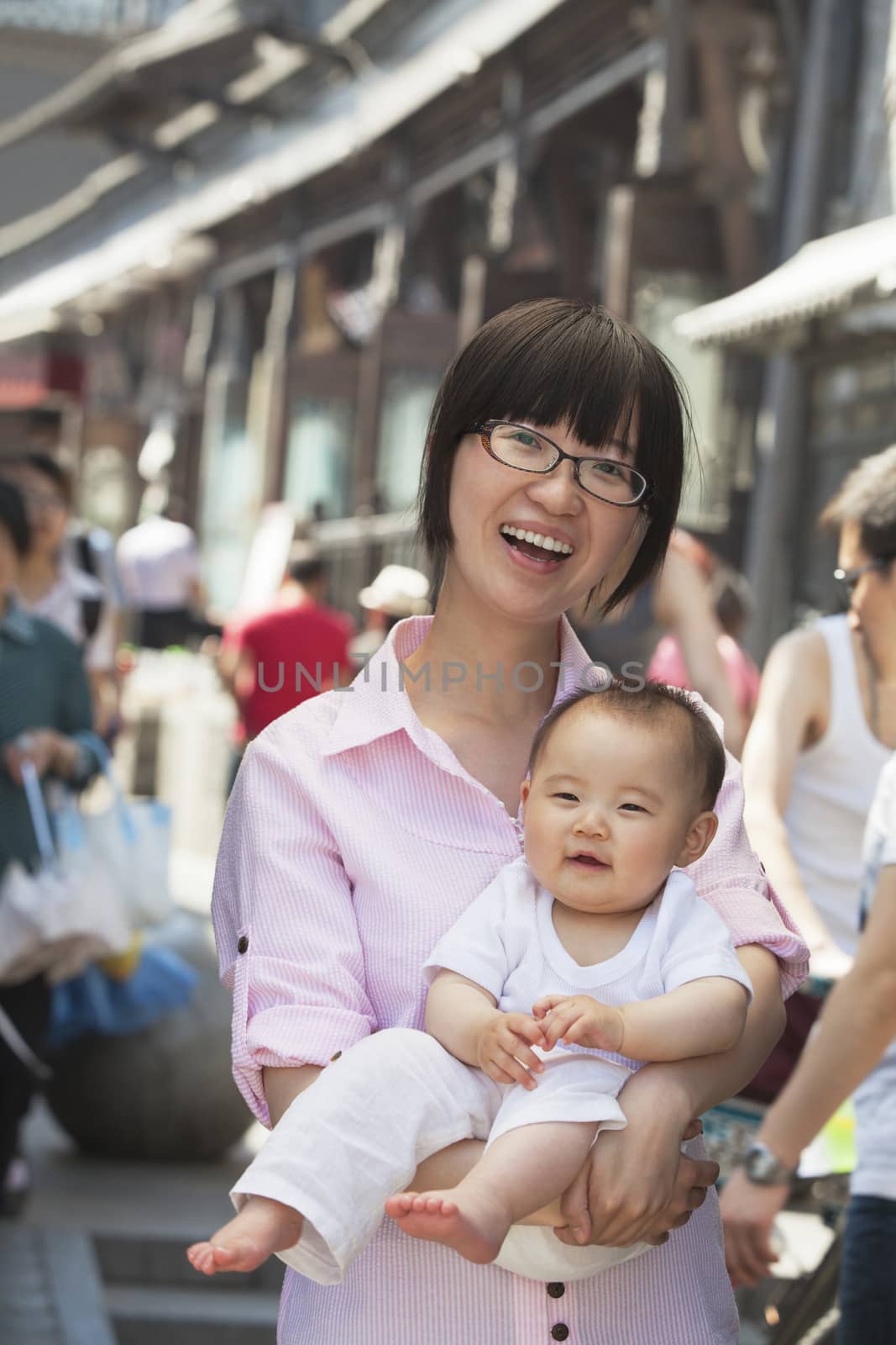 Portrait of mother holding her baby son, outdoors Beijing