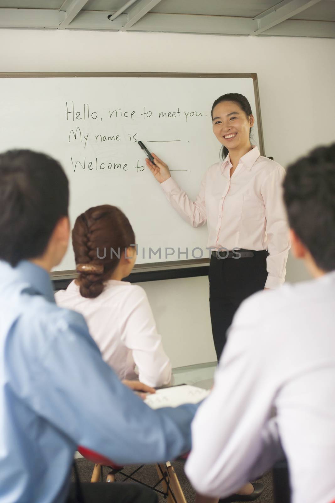 Office worker teaching coworkers 