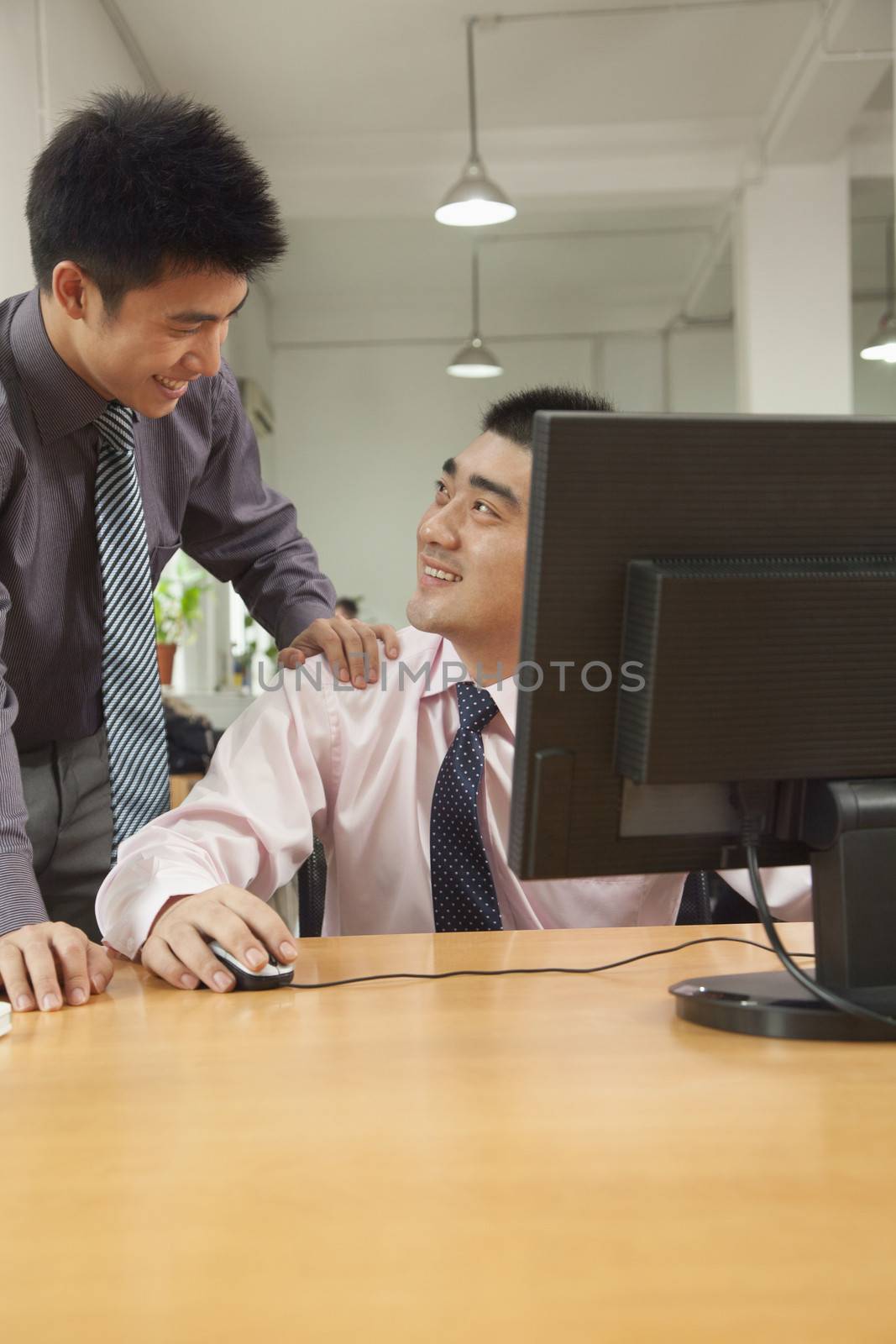 coworkers discussing the project over the computer screen 