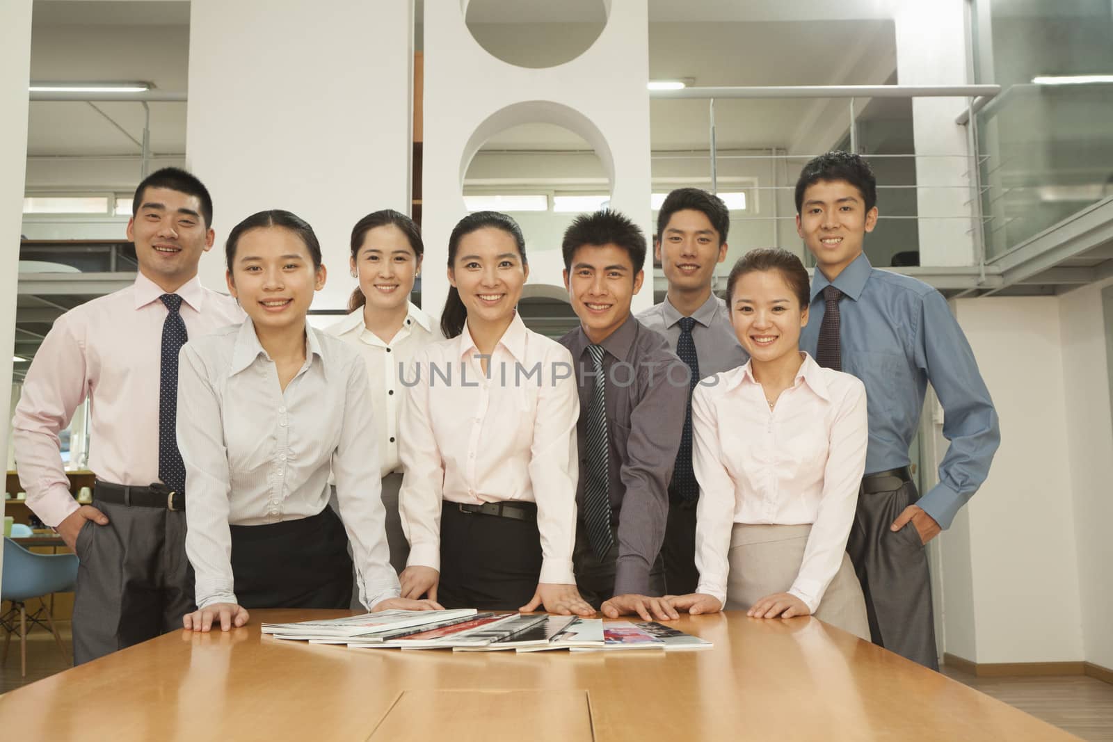 Office team standing near the desk, portrait by XiXinXing