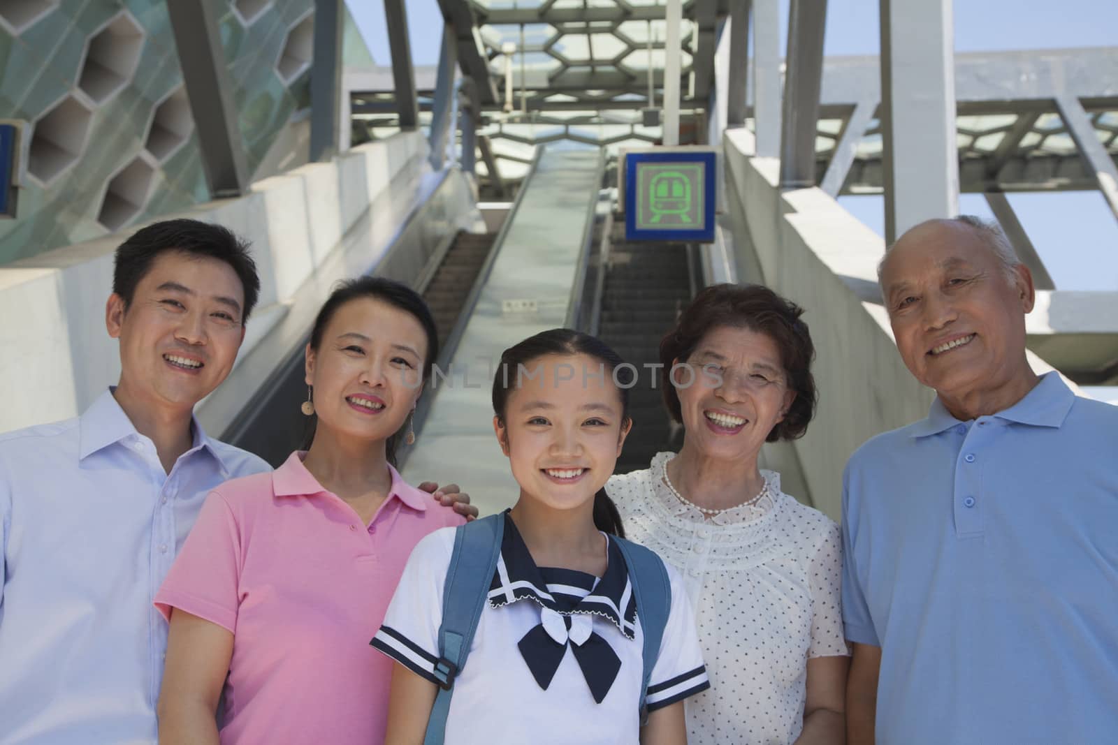 Family standing next to the escalator near the subway station by XiXinXing