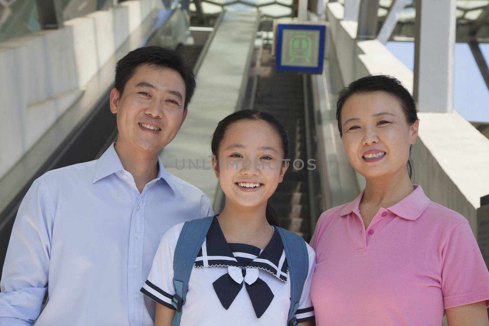 Family standing next to the escalator near the subway station