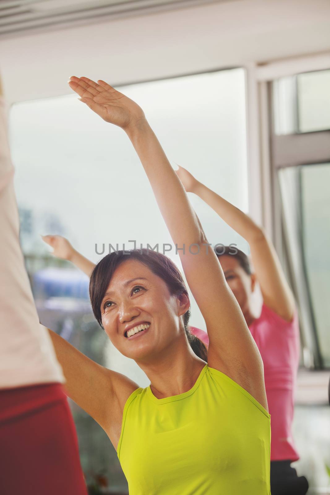 Mature women exercising in the gym  by XiXinXing