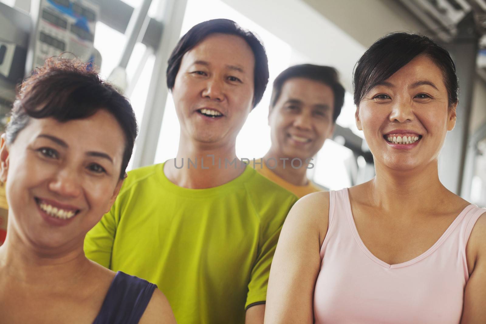 Group of people exercising in the gym, portrait by XiXinXing