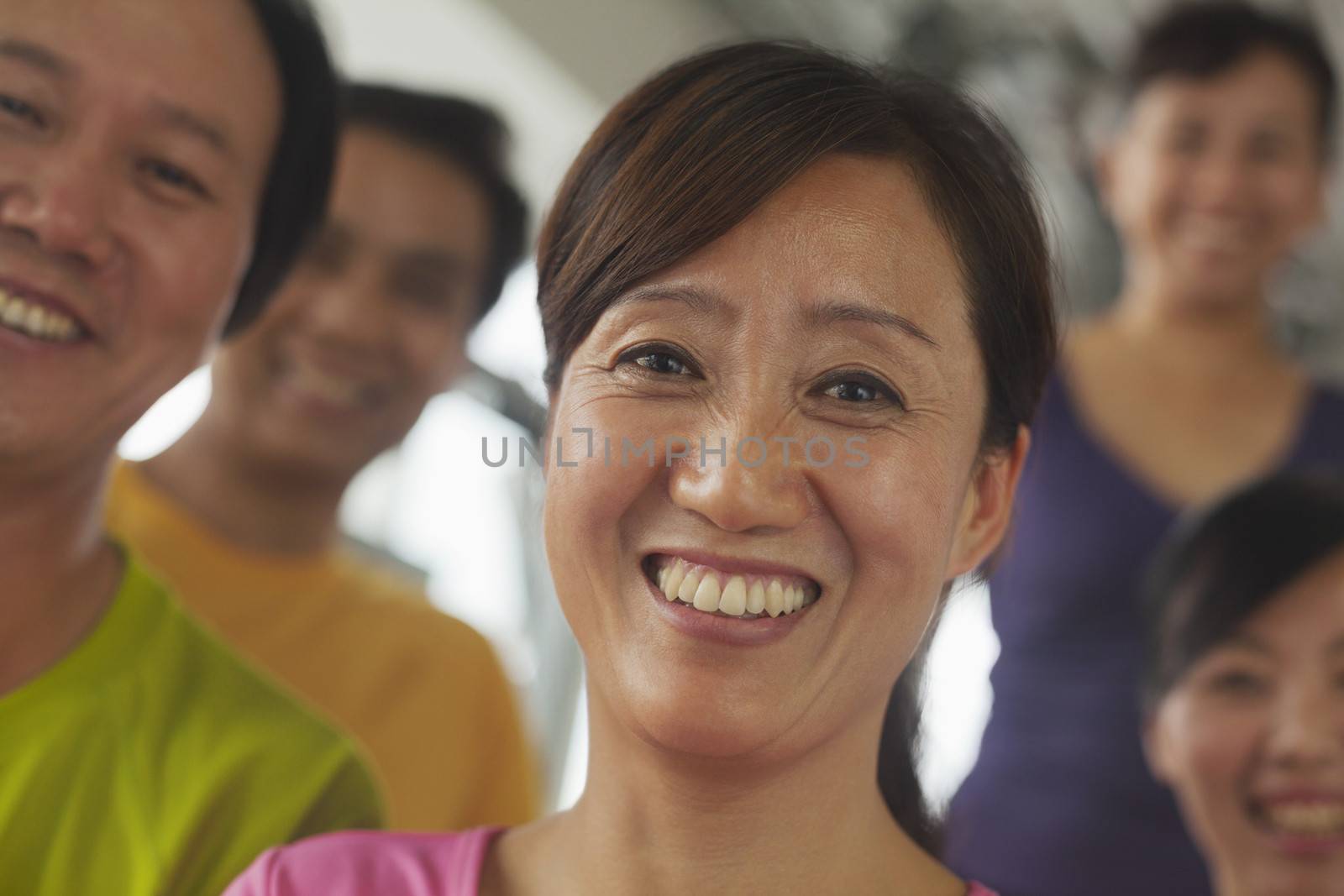 Group of people exercising in the gym, portrait