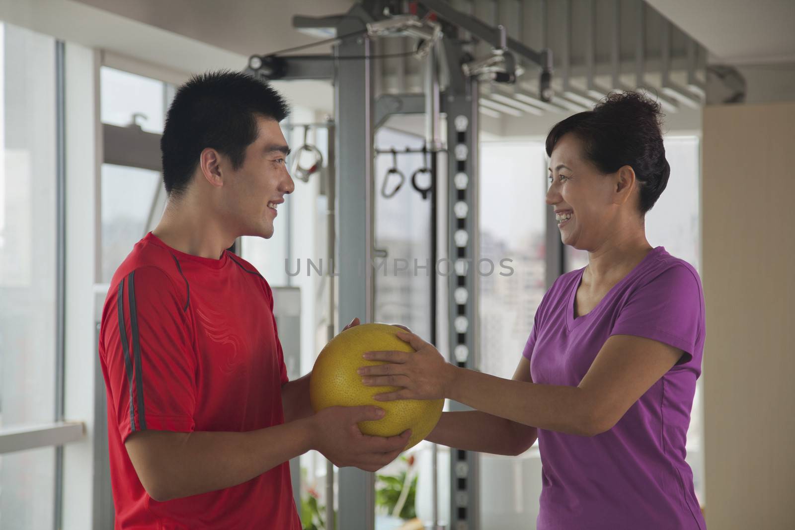 Mature woman exercising with her trainer