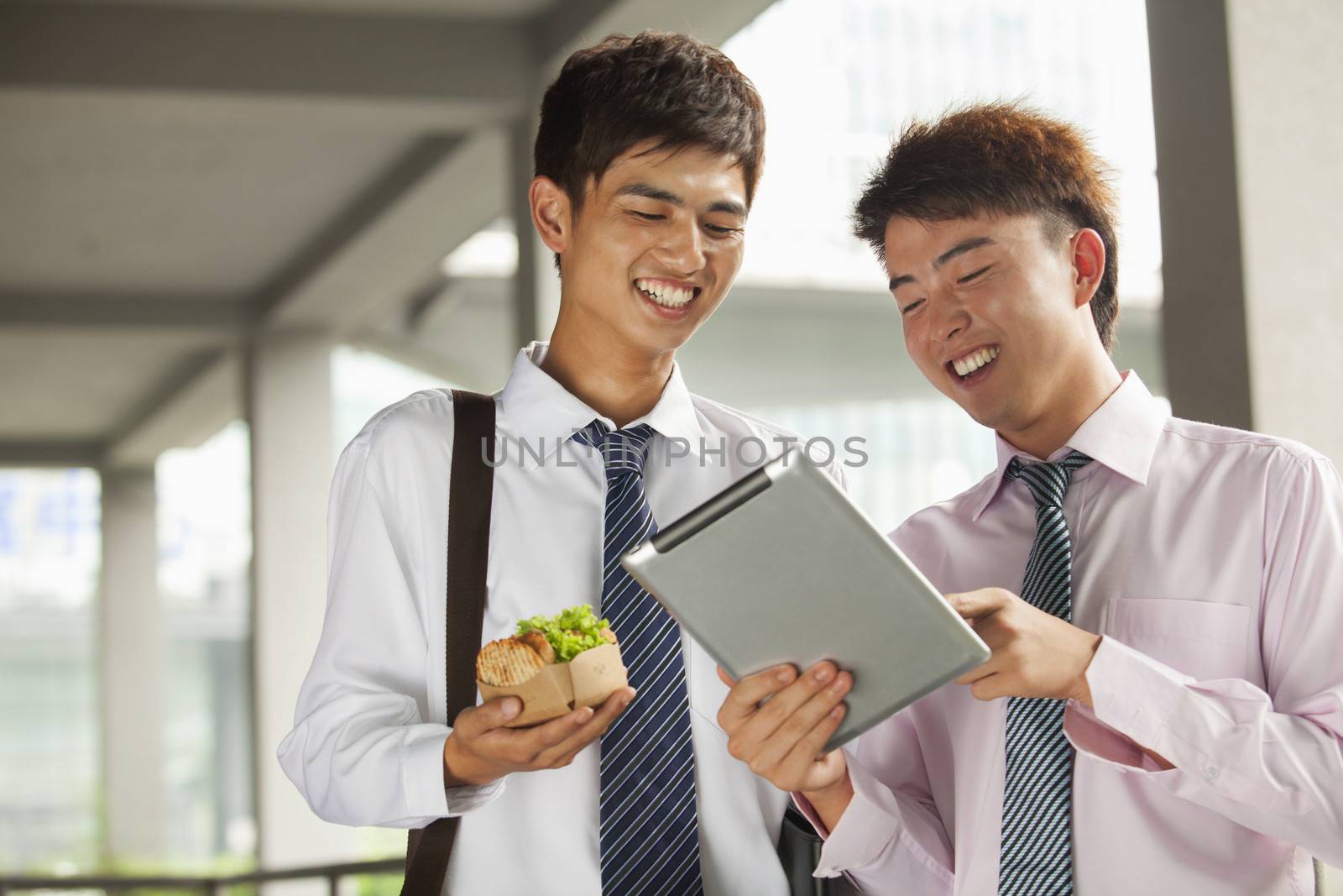 Two young businessmen working outdoor 