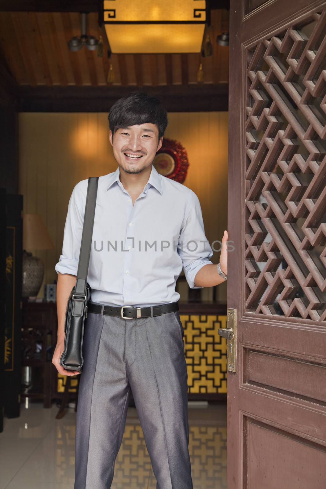 Young Businessman in Traditional Doorway by XiXinXing
