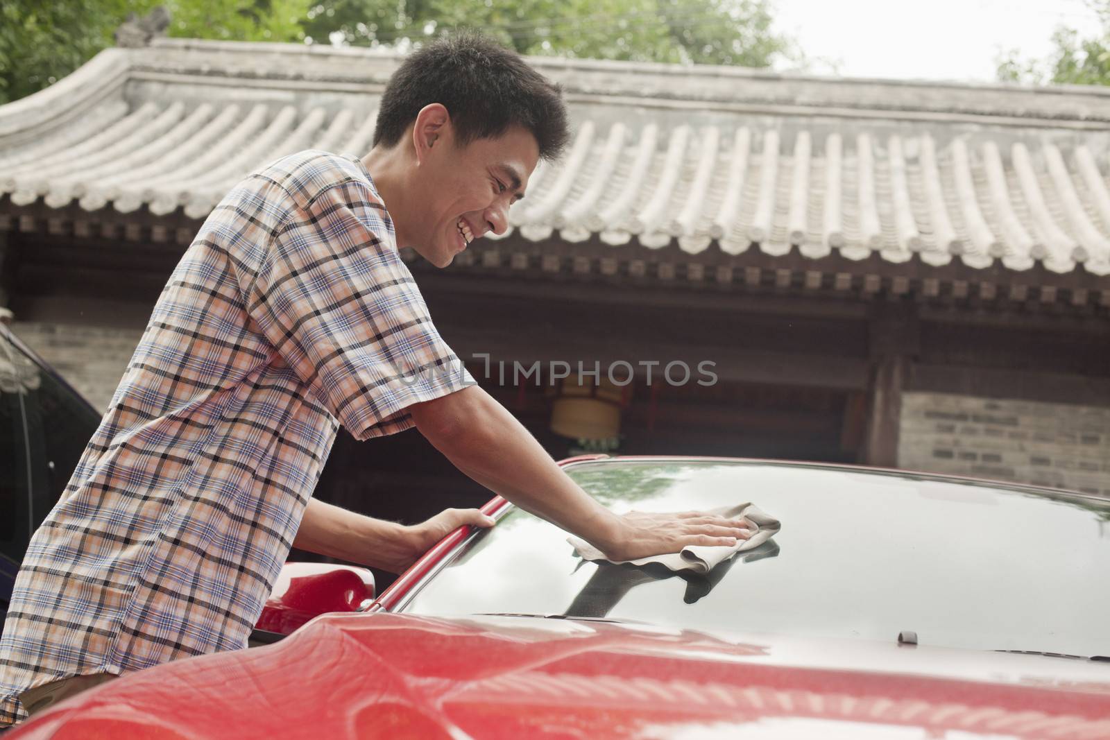 Young Man Cleaning His Car