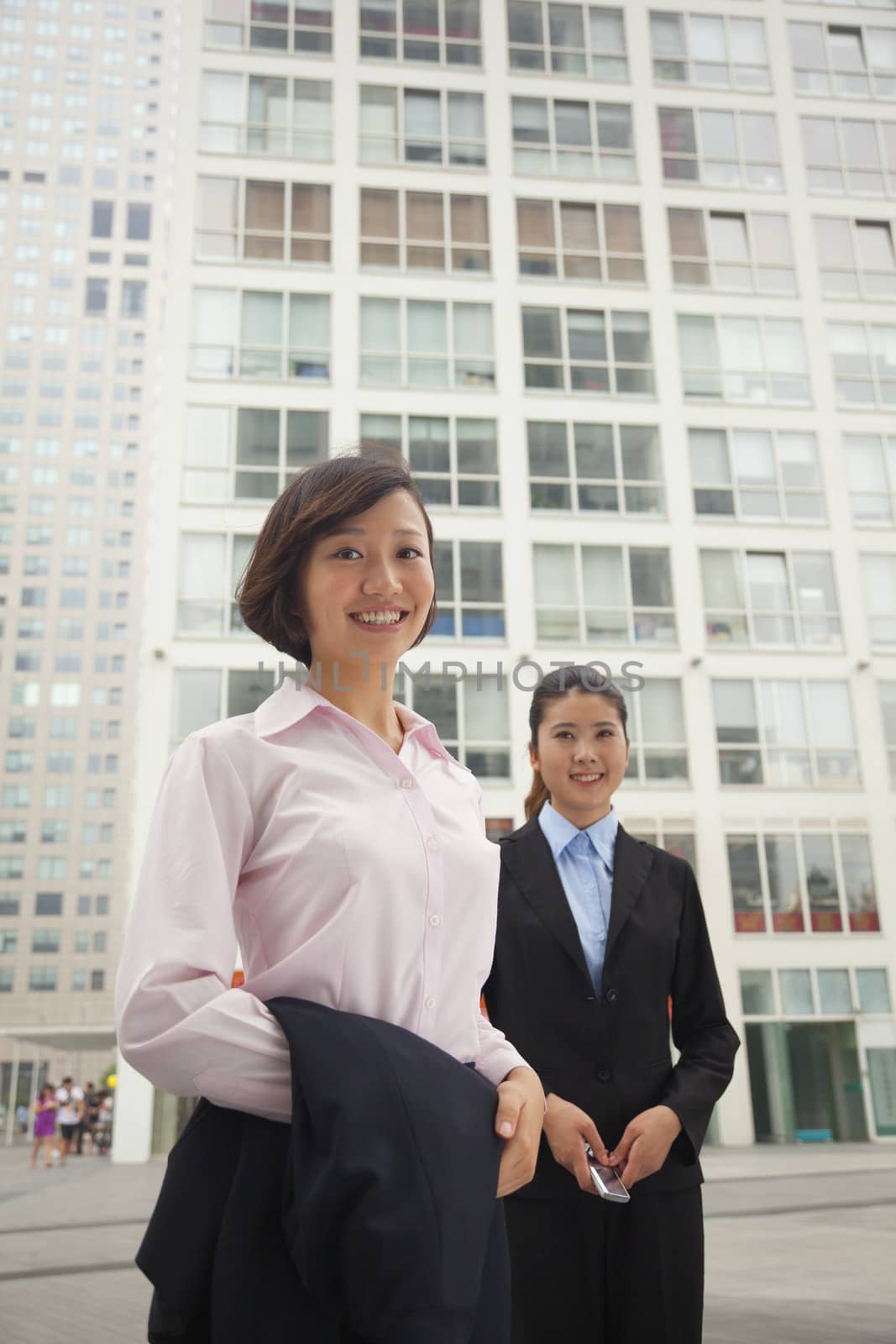 Young business women standing outside of CBD, portrait