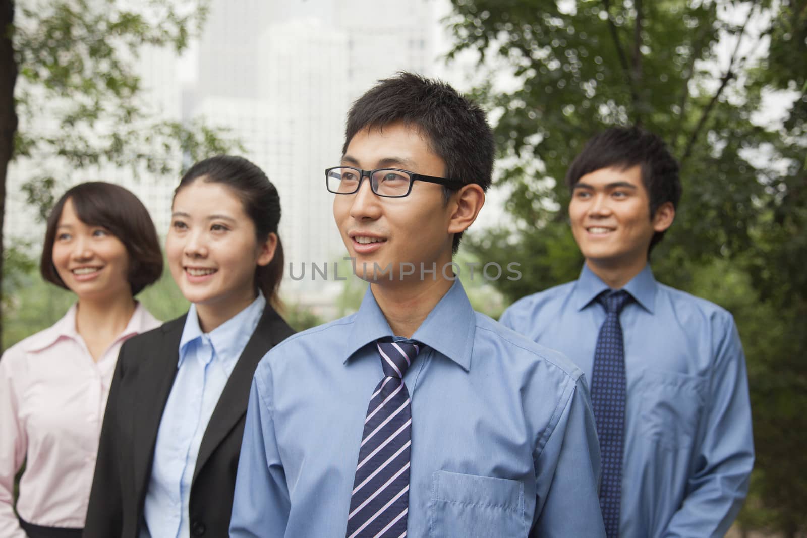 Young business people in the park, portrait by XiXinXing
