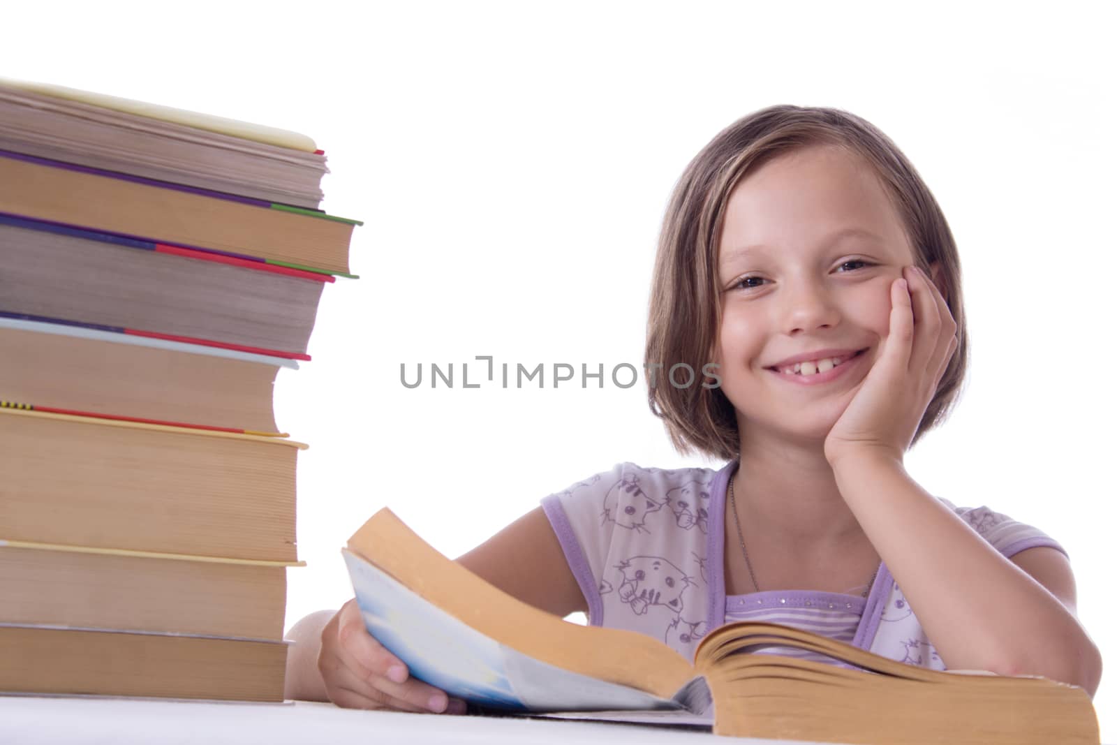 Smiling girl with pile of books isolated on white