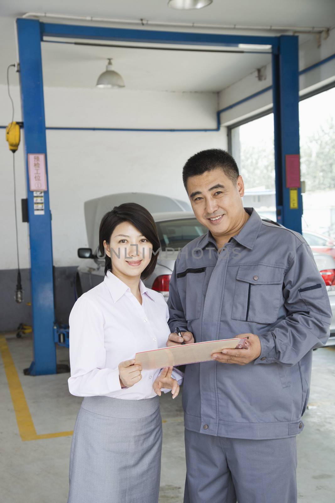 Garage Mechanic Explaining to Customer