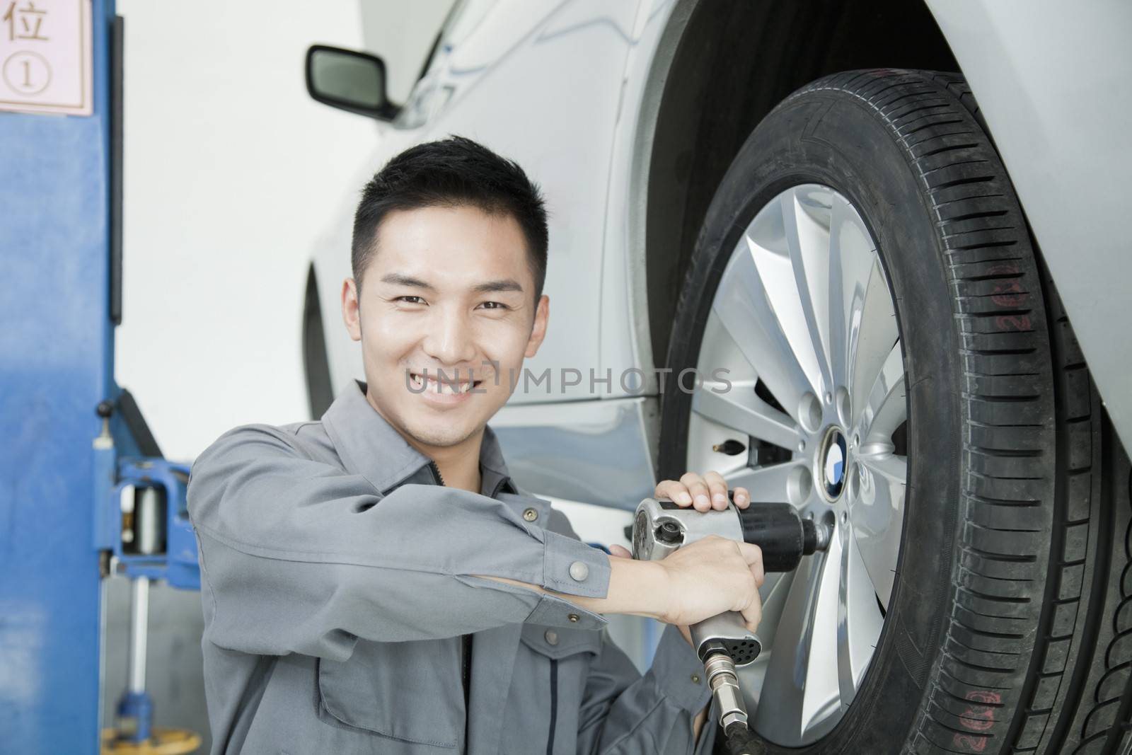 Mechanic Using Power Tool