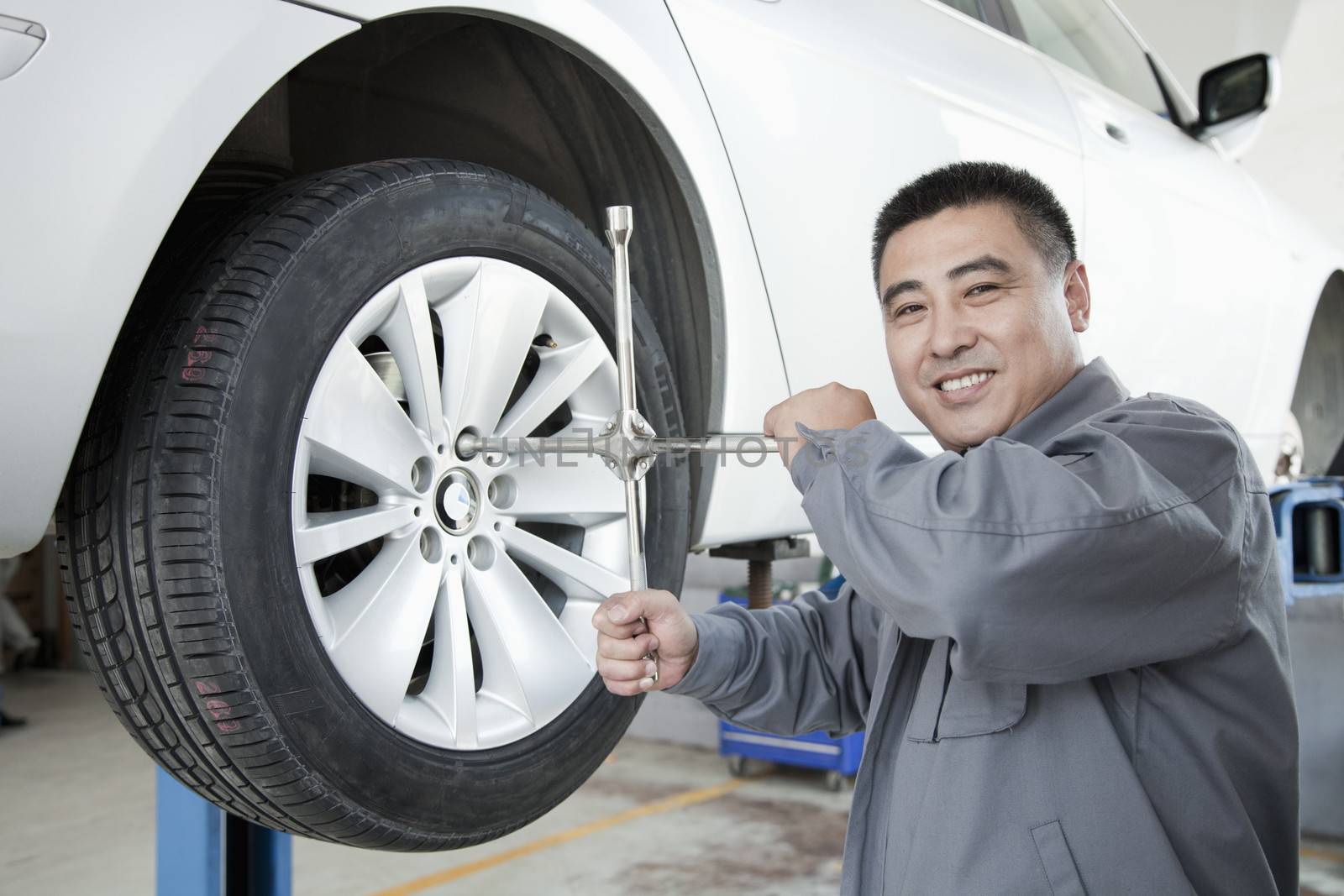 Mechanic Adjusting Tire