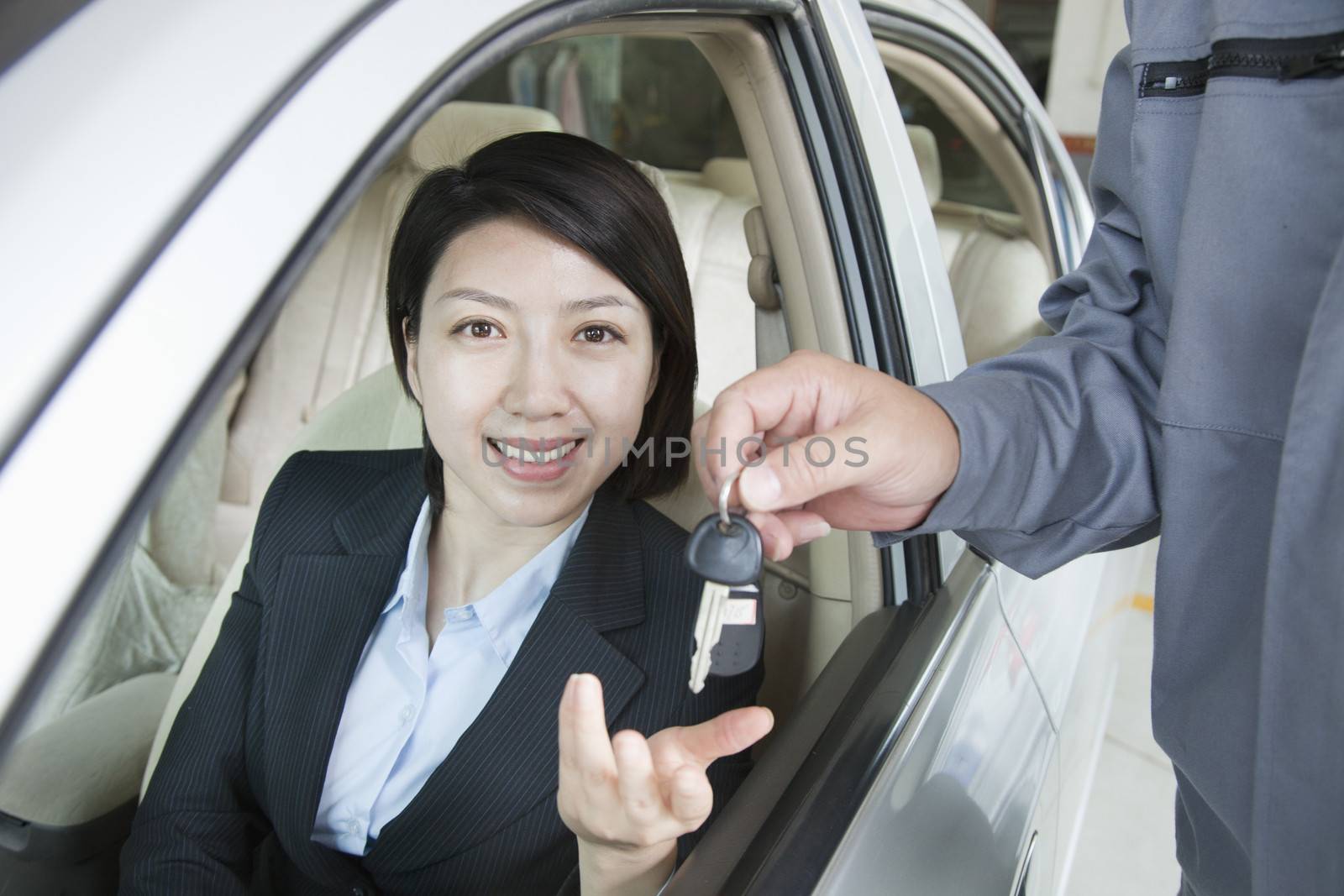 Mechanic Handing Keys to Businesswoman by XiXinXing