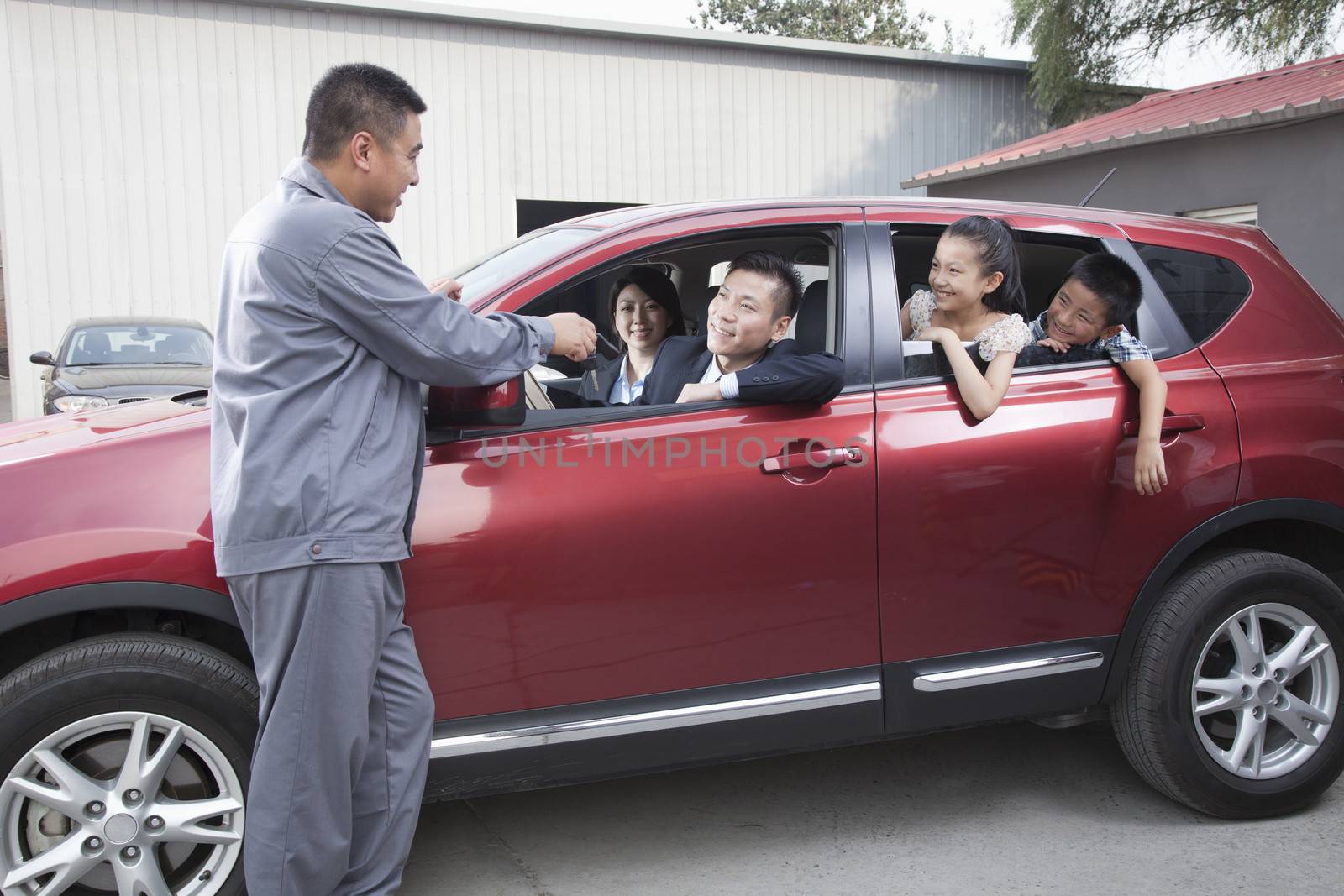 Mechanic Giving Car Keys to Family