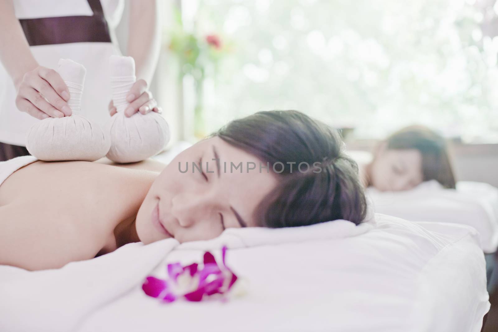 Women Receiving Herbal Massage by XiXinXing