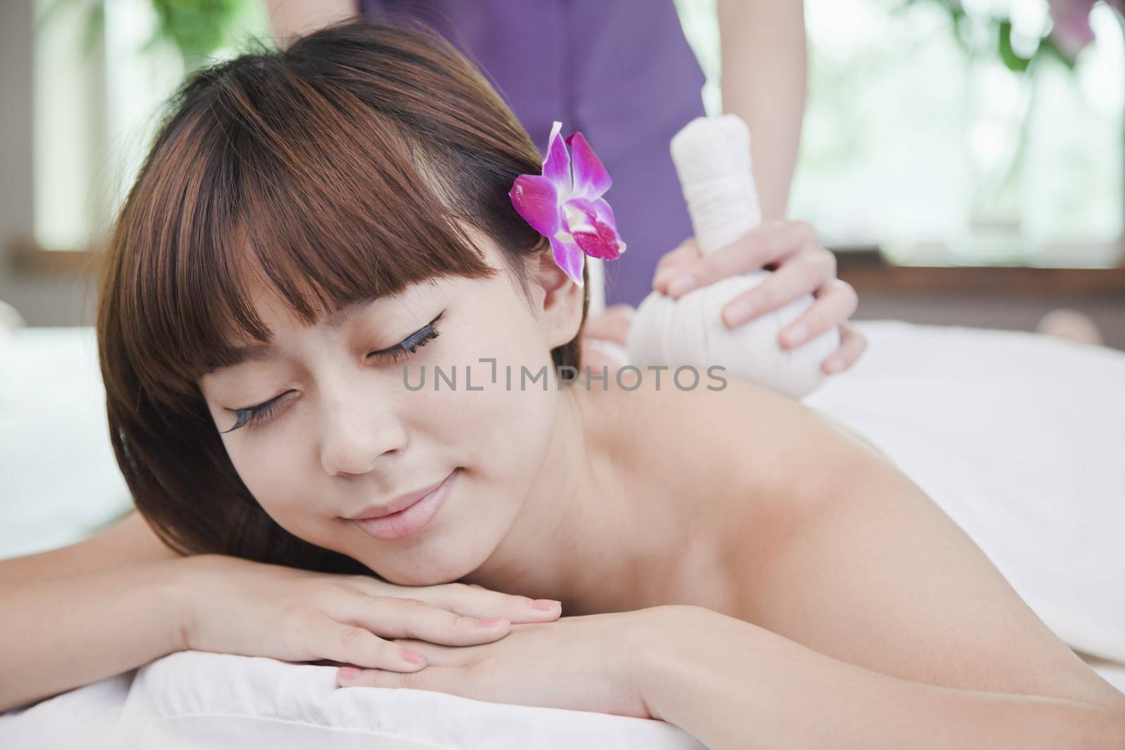 Woman Receiving Herbal Massage