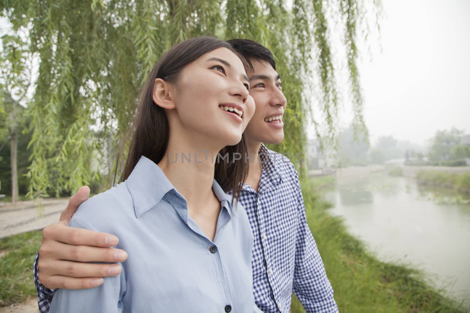 Young Couple Sitting by a Canal by XiXinXing