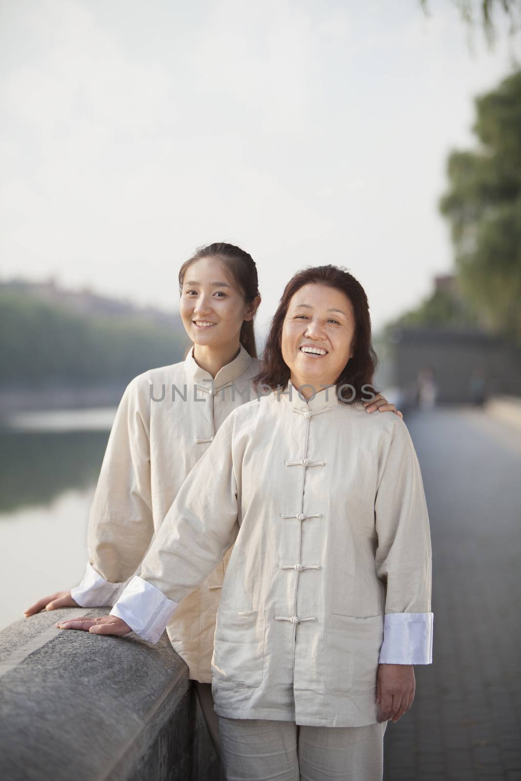 Two Chinese Women With Tai Ji Clothes Smiling At Camera by XiXinXing