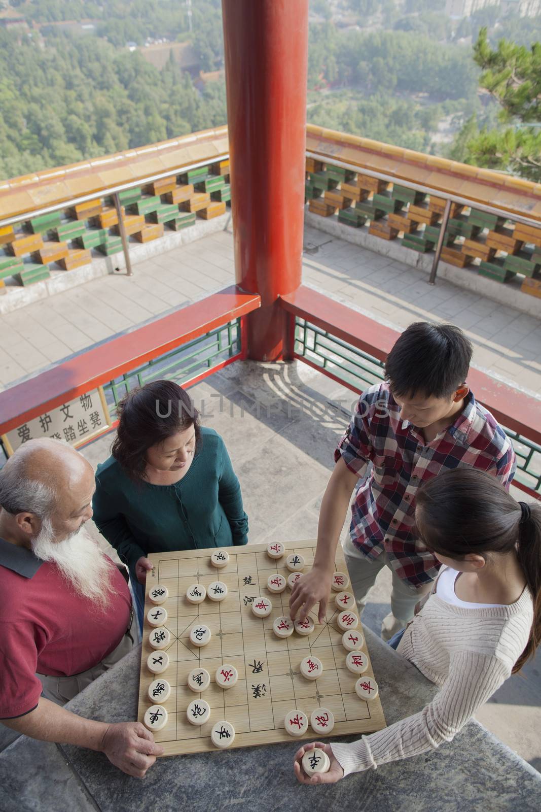 Chinese Family Playing Chinese Chess (Xiang Qi) by XiXinXing