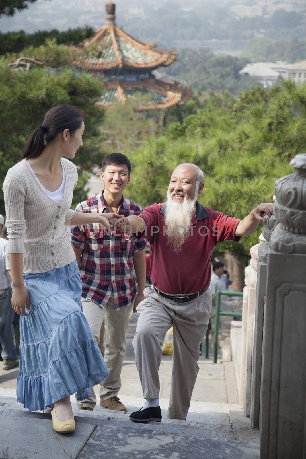 Chinese Family Walking In Jing Shan Park by XiXinXing