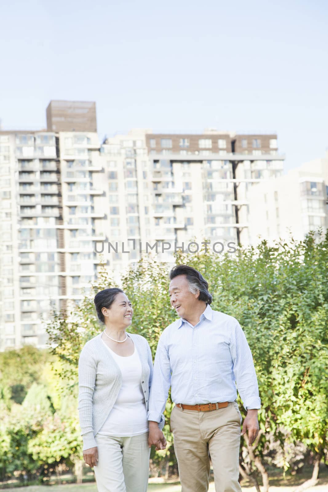 Mature couple walking in the park  by XiXinXing