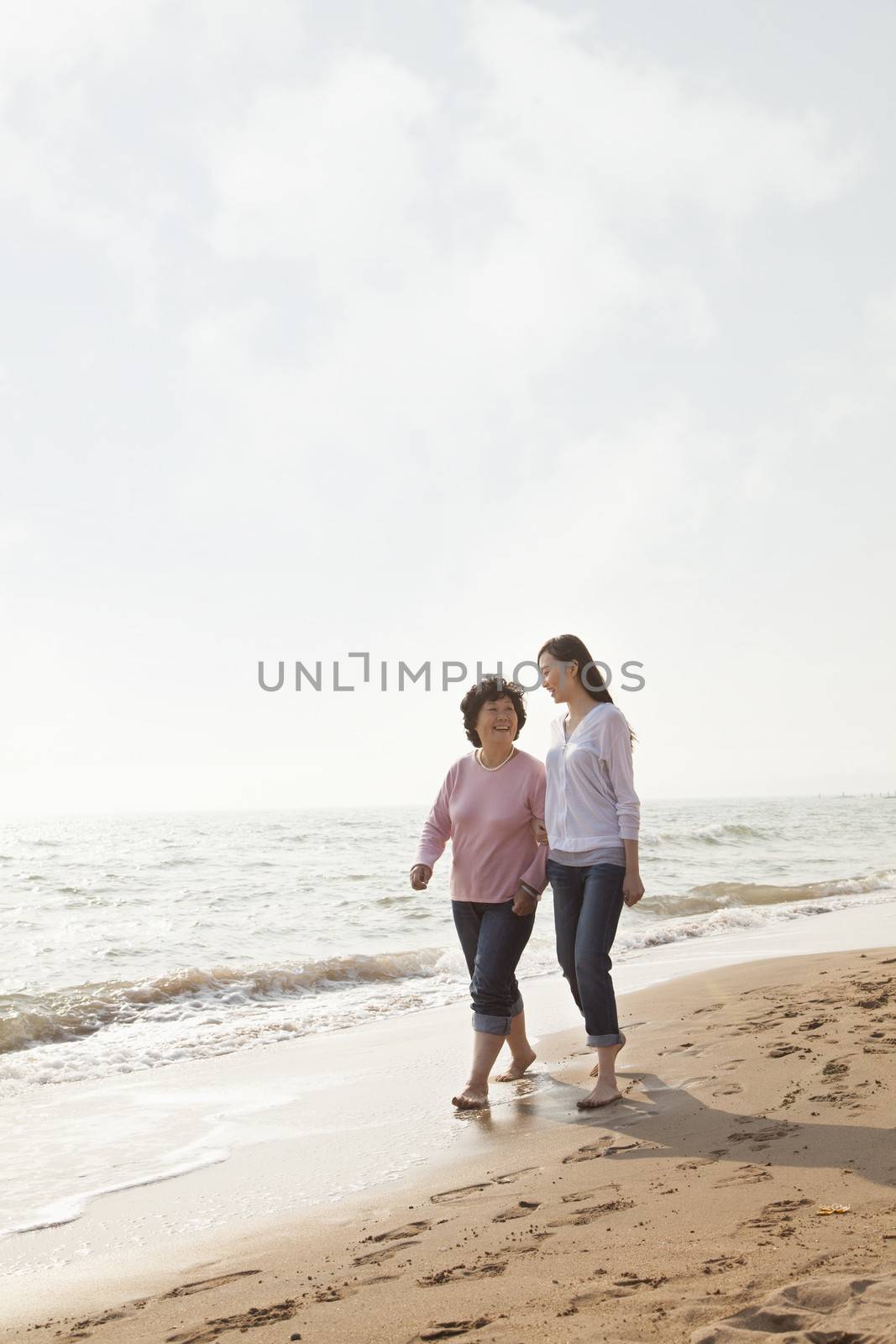 Grandmother and Granddaughter Taking a Walk by the Beach