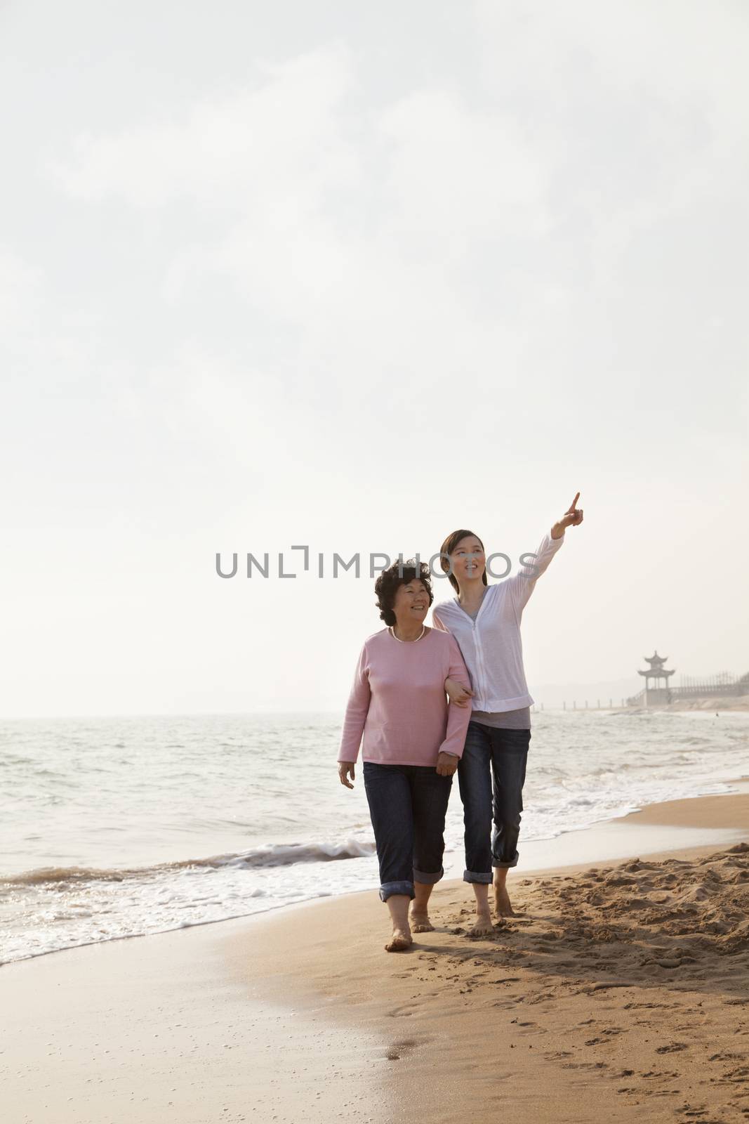 Grandmother and Granddaughter Taking a Walk by the Beach by XiXinXing