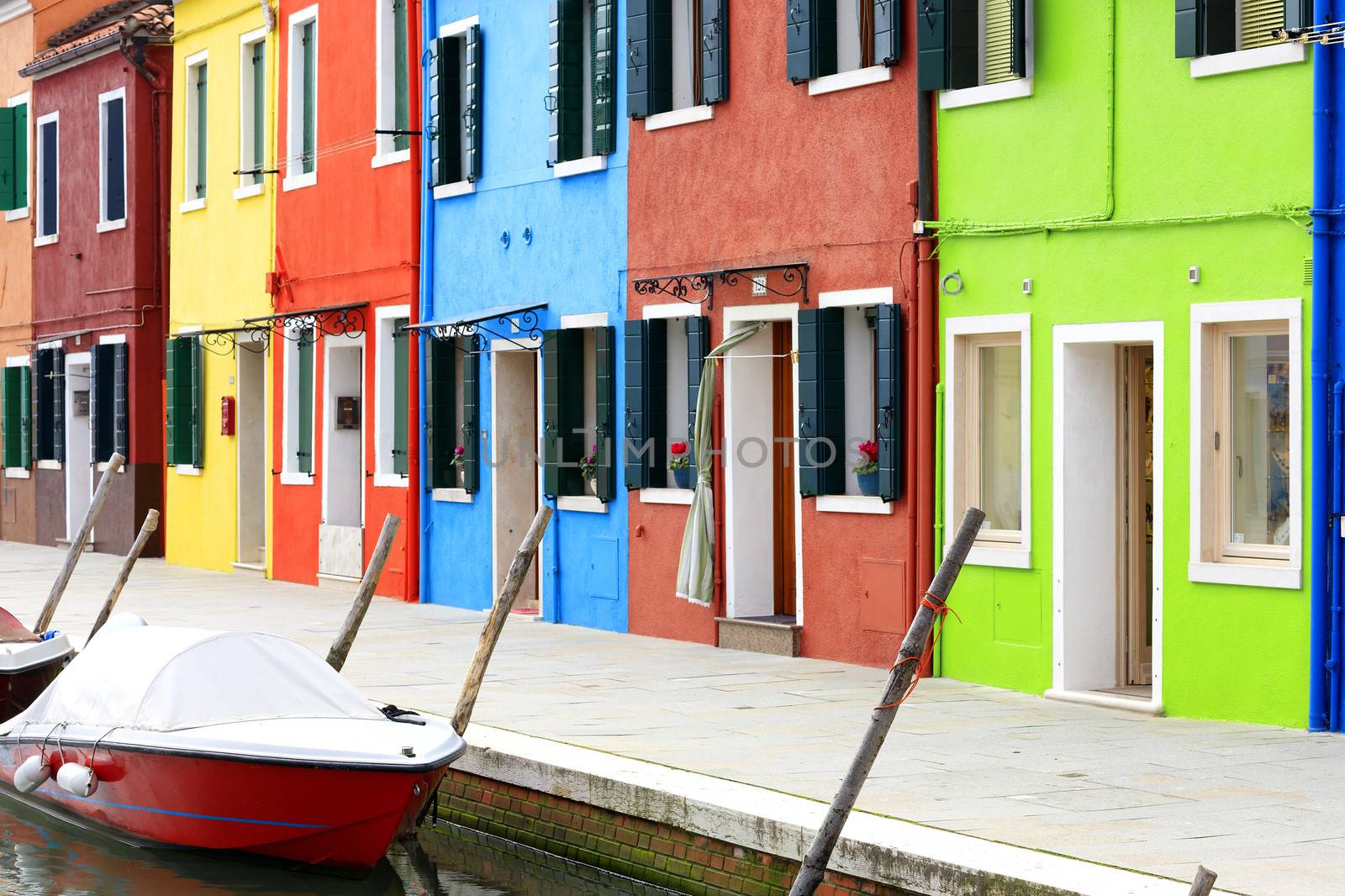 Burano island canal, small colored houses and the boats