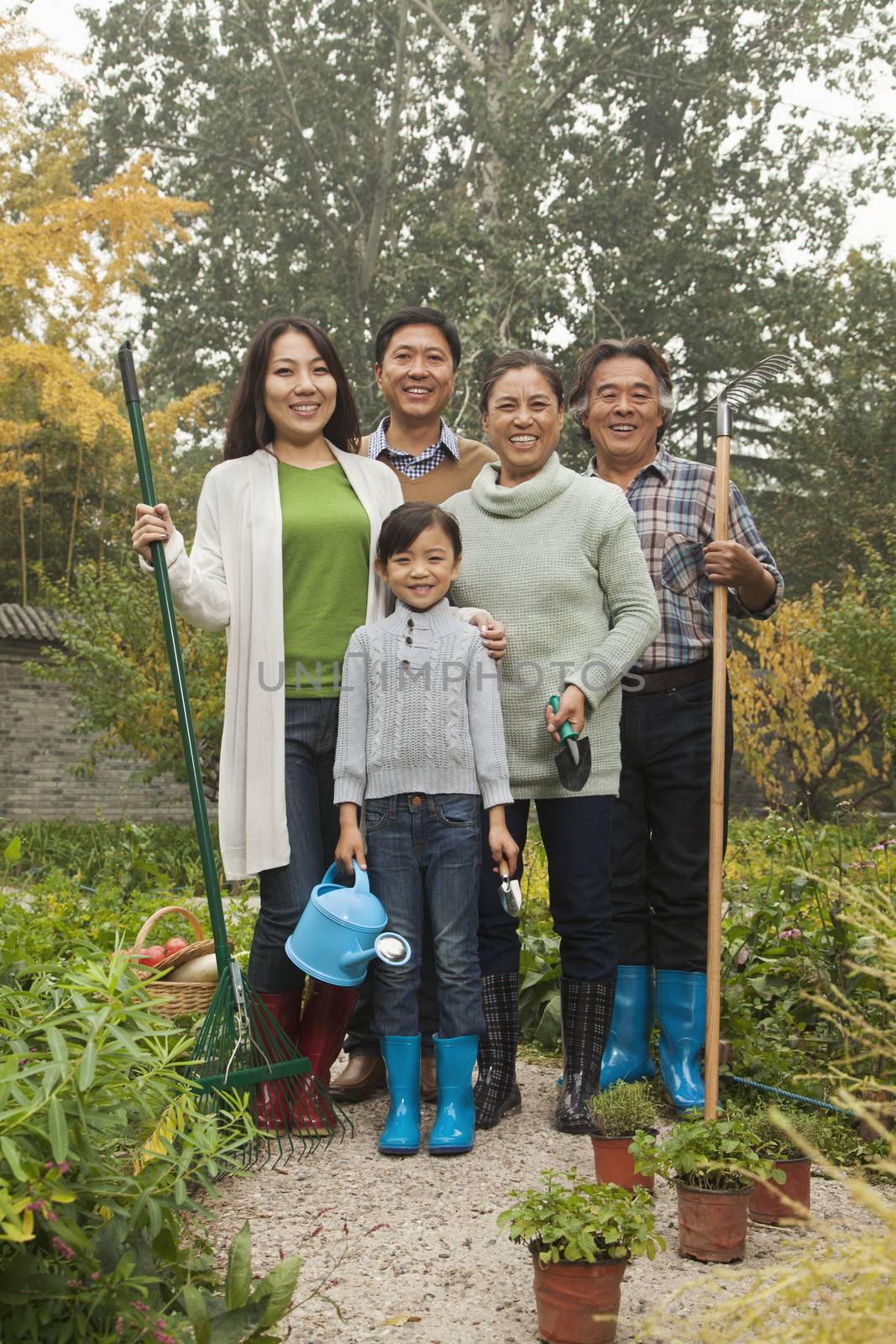 Happy family working in garden by XiXinXing