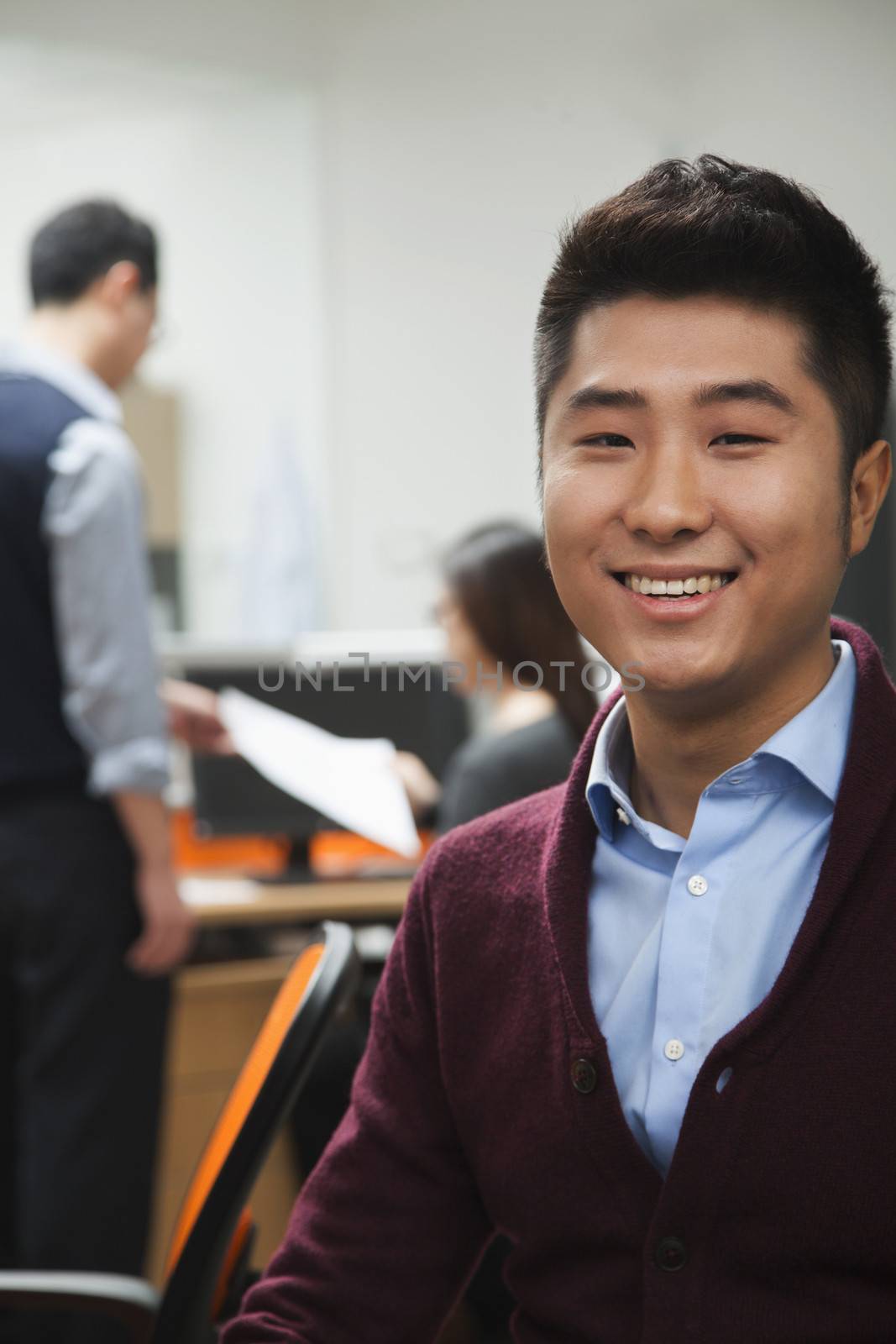 Portrait of young businessman in the office by XiXinXing