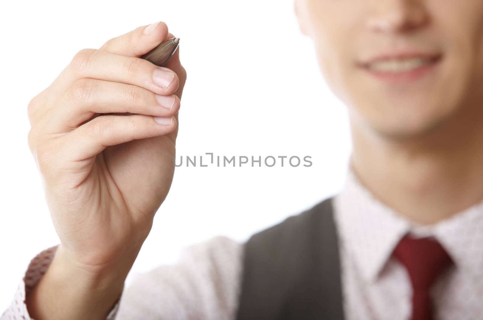 Young smiling businessman is writing on a virtual whiteboard. Focus is on the hand and pen