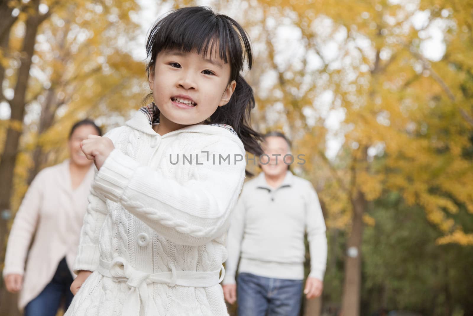 Grandparents and granddaughter in park by XiXinXing