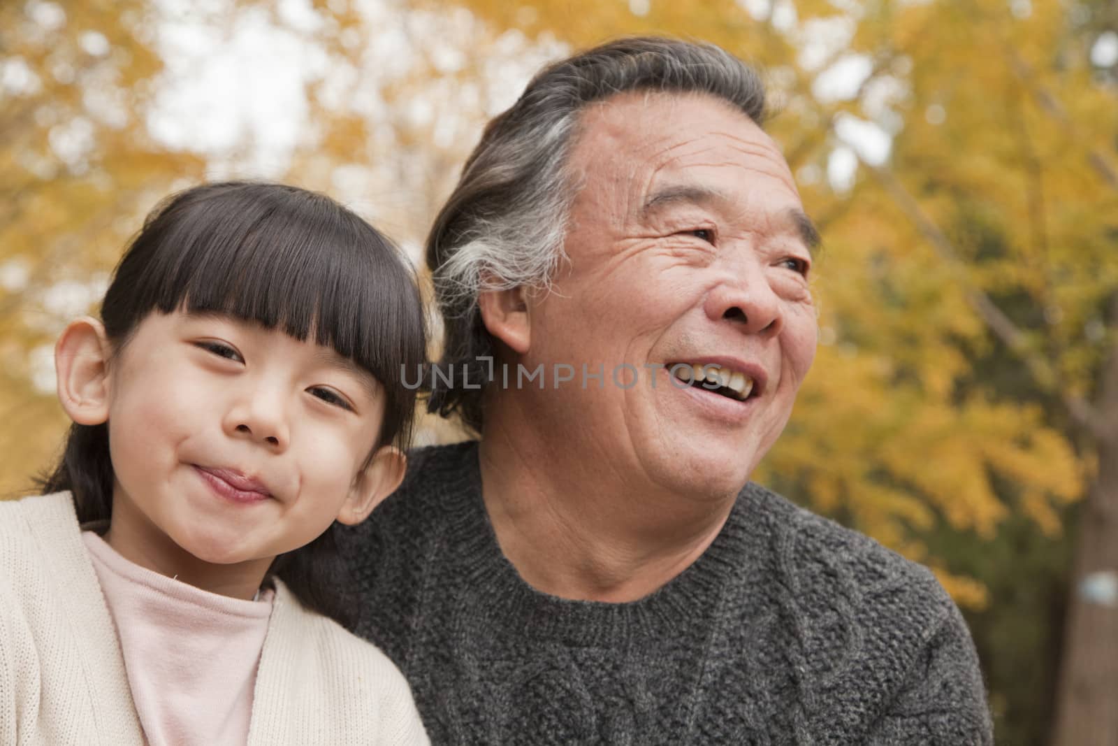 Grandfather and granddaughter in park by XiXinXing