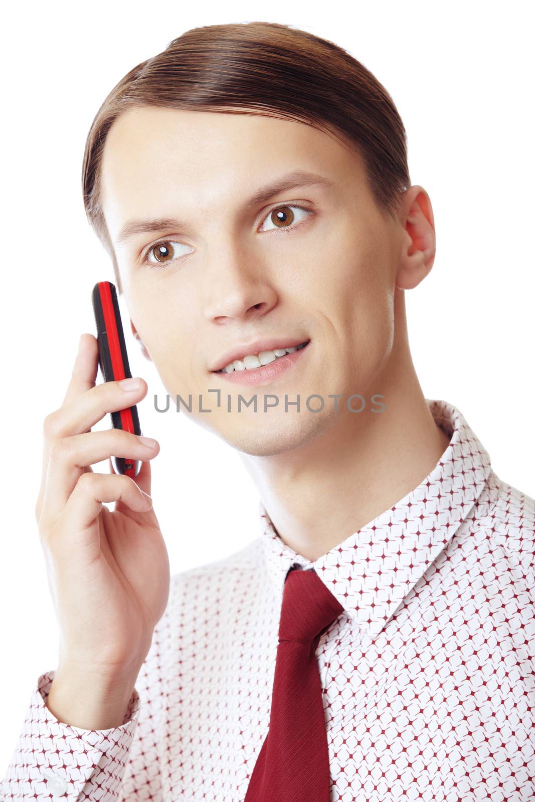 Smiling businessman talking via cell phone on a white background