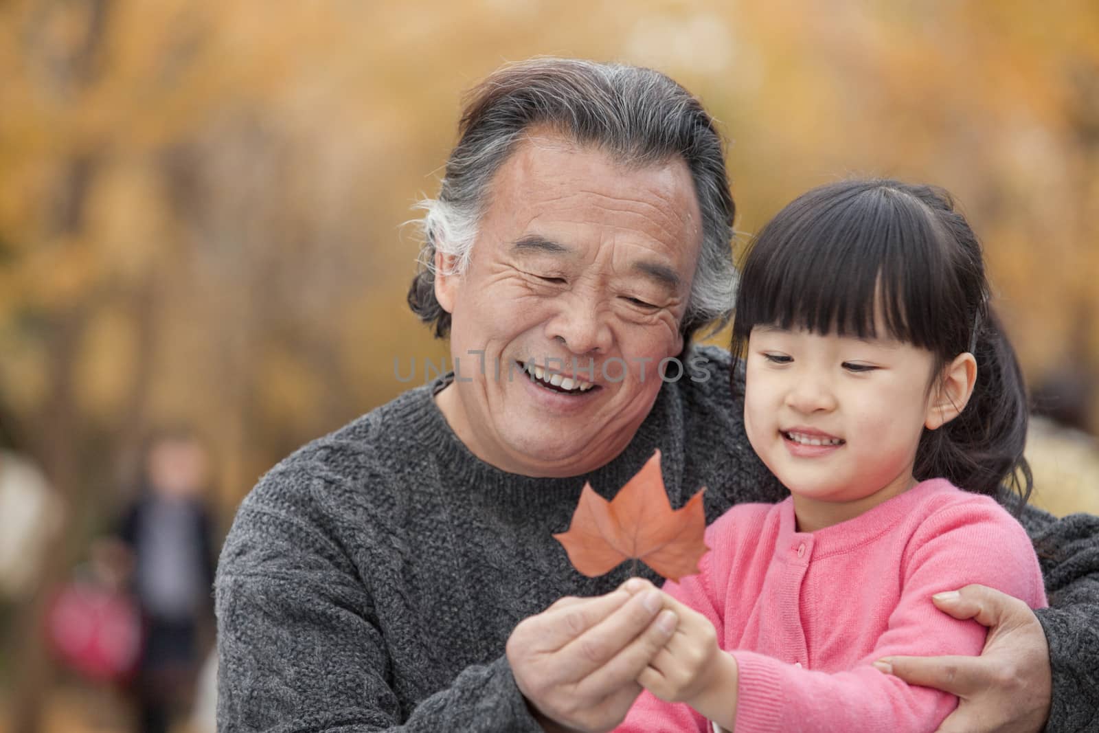 Grandfather and granddaughter in park by XiXinXing
