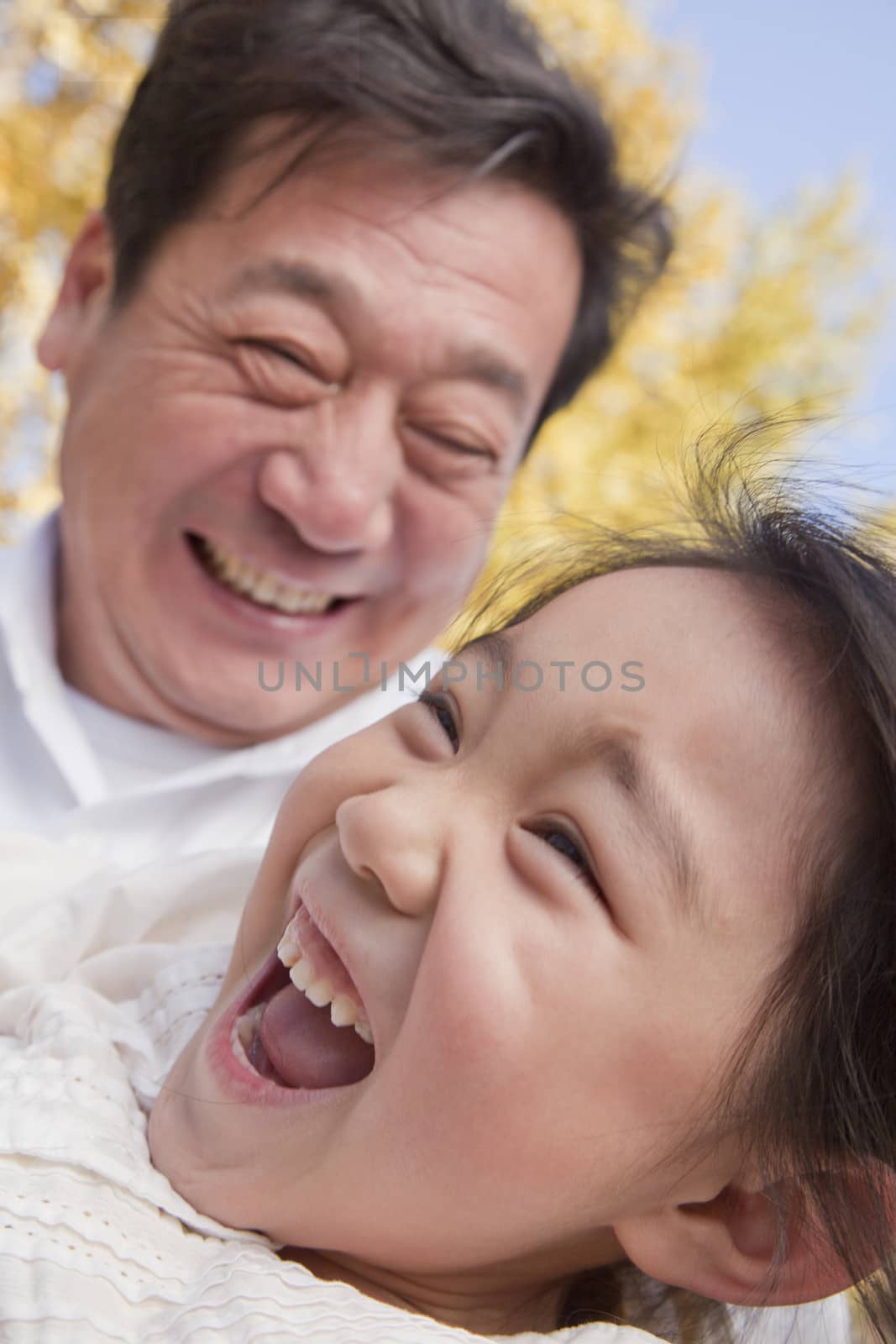 Grandfather and Granddaughter Playing in the Park by XiXinXing