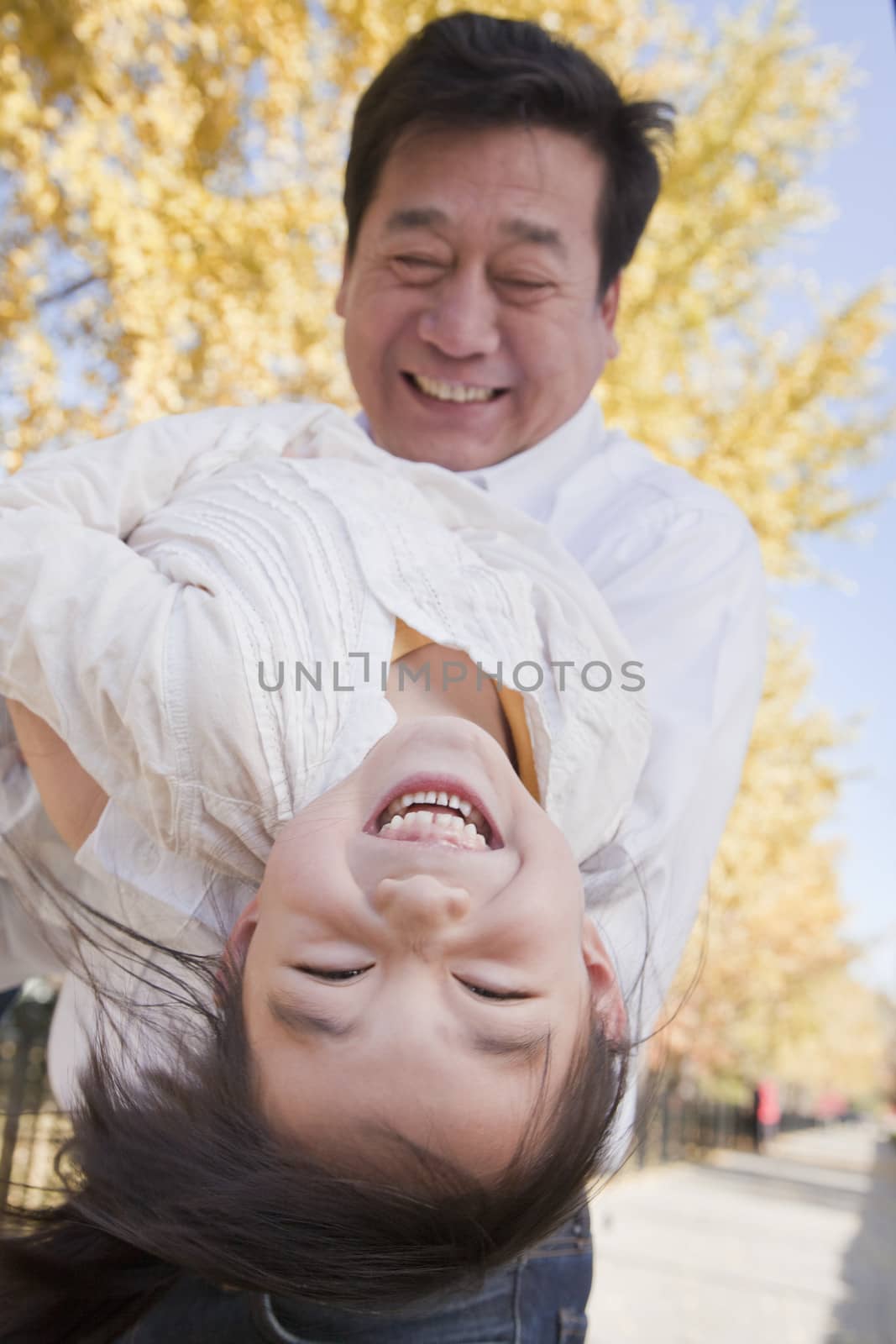 Grandfather and Granddaughter Playing in the Park by XiXinXing